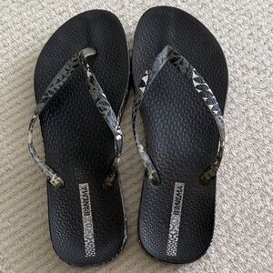 Ipanema Black Flip Flops with Metallic Gray Patterned Straps